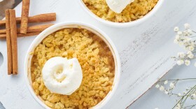 Apple crumble with ice cream, streusel. Morning breakfast on light gray table. Top view, close up