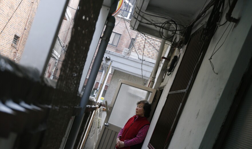 South Korea's Confucian tradition has weakened, and now elderly South Koreans increasingly live alone. In this photo from 2013, Kong Kyung-soon, a 73-year-old who lives alone, looks out of the door of her tiny rented apartment in Seoul.