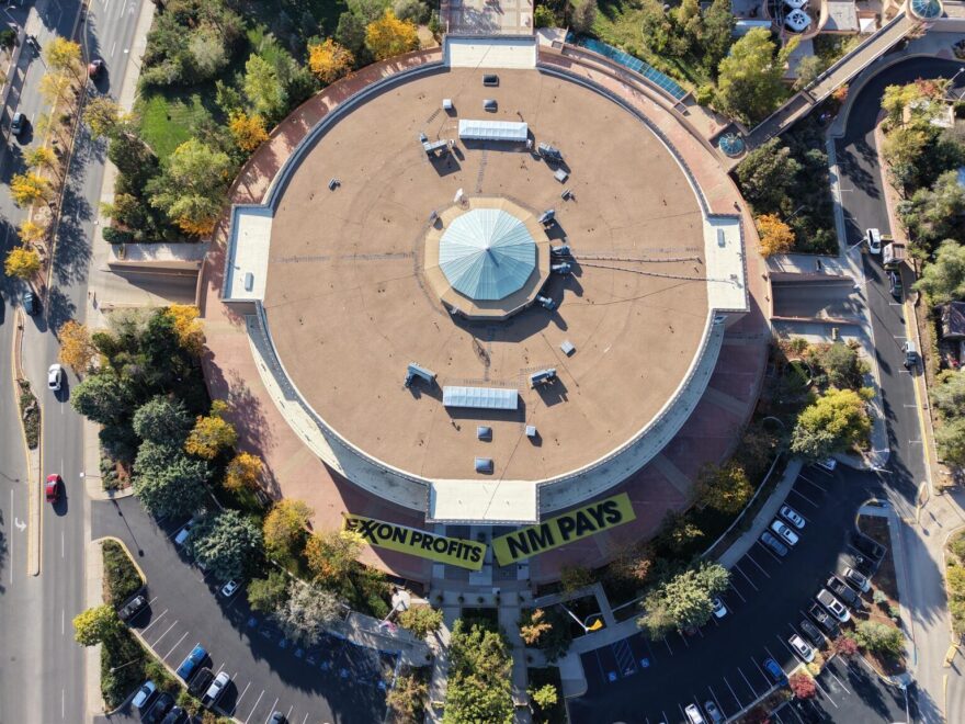 Environmental activists unfurled banners dozens of feet long in front of the Roundhouse on Oct. 7, 2025, protesting the sponsorship of oil and gas conglomerate Exxon-Mobil. (Courtesy of Youth United Against Climate Crisis)
