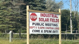 A sign in Cheboygan, MI calling for residents to show up an oppose a proposed solar panel installation at a public meeting on September 10th, 2026