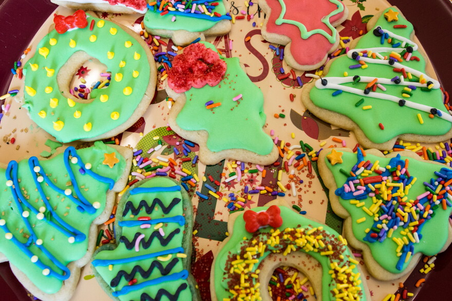 Decorated christmas sugar cookies with sprinkles and royal icing.