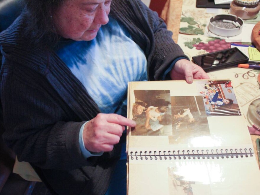 Pam Grillo points to a photo of her son, Kevin Mock, as a young child in a family album at her home in Greenwood, Ind., on Thursday, April 10. Kevin spent months in the Johnson County Jail awaiting a court-ordered competency evaluation.