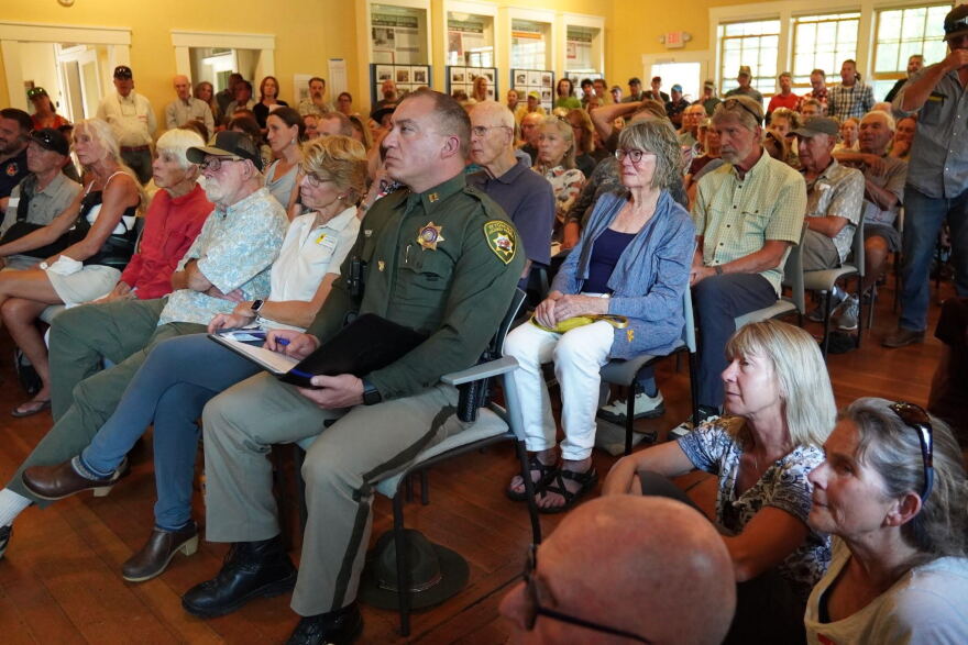 Community members pack the Old Wilson Schoolhouse Community Center on Aug. 7, 2026.