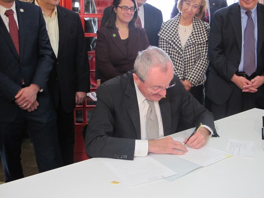 Governor Phil Murphy signs the executive order at Tigerlabs in Princeton