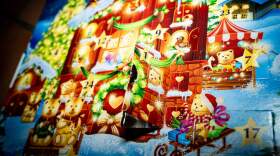A person opens the first box of their advent calendar and takes out a Lindt chocolate bear. (Amaury Cornu/AFP via Getty Images)
