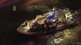 Rescued sailors are seen on board a smaller boat after leaving the Silver Muna tanker ship on Wednesday, Dec. 14, 2022 in New York. Two men who went missing in the Atlantic Ocean for 10 days after a storm hit their sailboat off North Carolina thanked the crew of the tanker that rescued them and said they were lucky to have survived.