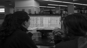 Library Programmer Krysta Wilham and Community Member Cassie Schball review census documents.