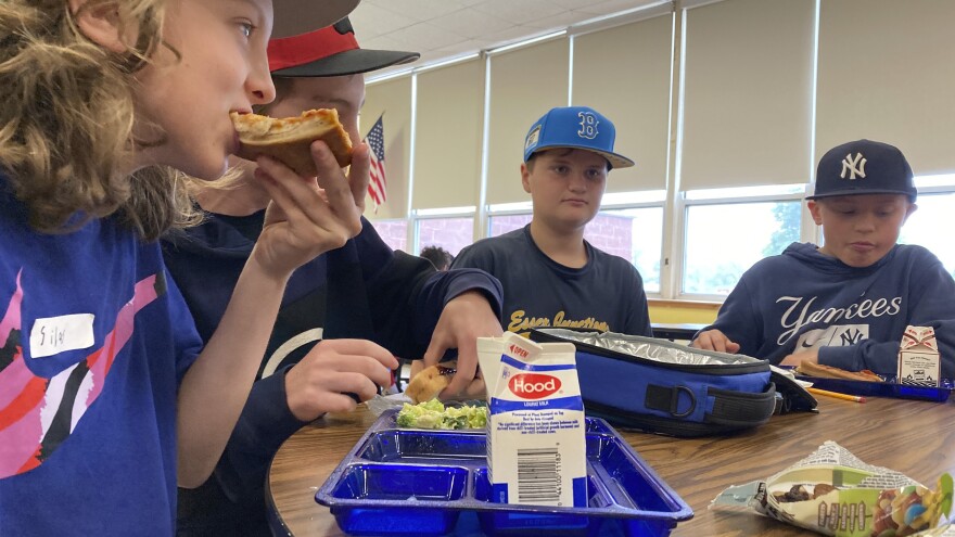 Students eat lunch of homemade pizza and caesar salad at the Albert D. Lawton Intermediate School, in Essex Junction, Vt., Thursday, June 9, 2022. The pandemic-era federal aid that made school meals available for free to all public school students — regardless of family income levels — is ending, raising fears about the effects in the upcoming school year for families already struggling with rising food and fuel costs. (AP Photo/Lisa Rathke)