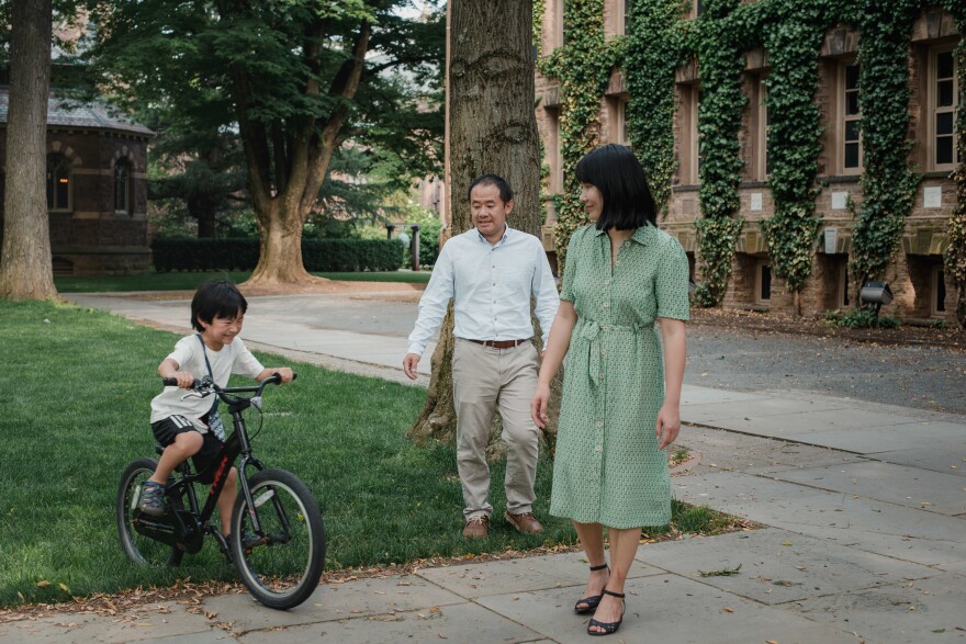 Wang and Qu watch as their 7-year-old son rides his bike around Princeton University in Princeton, N.J. When Wang left for Iran, their son was 3 years old.