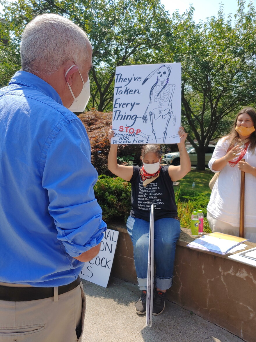 Shinnecock member Rebecca Genia confronts Southampton Town Supervisor Jay Schneiderman about delays in passing the Graves Protection Act  which would protect sacred Shinnecock burial grounds