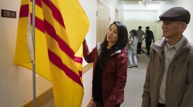 Thanh Tan stands with her father, Duc Tan, as they look at the South Vietnamese flag, at Hung Vuong Vietnamese Language School inside the Lutheran Church of the Good Shepherd on Friday, September 29, 2017, in Olympia. 