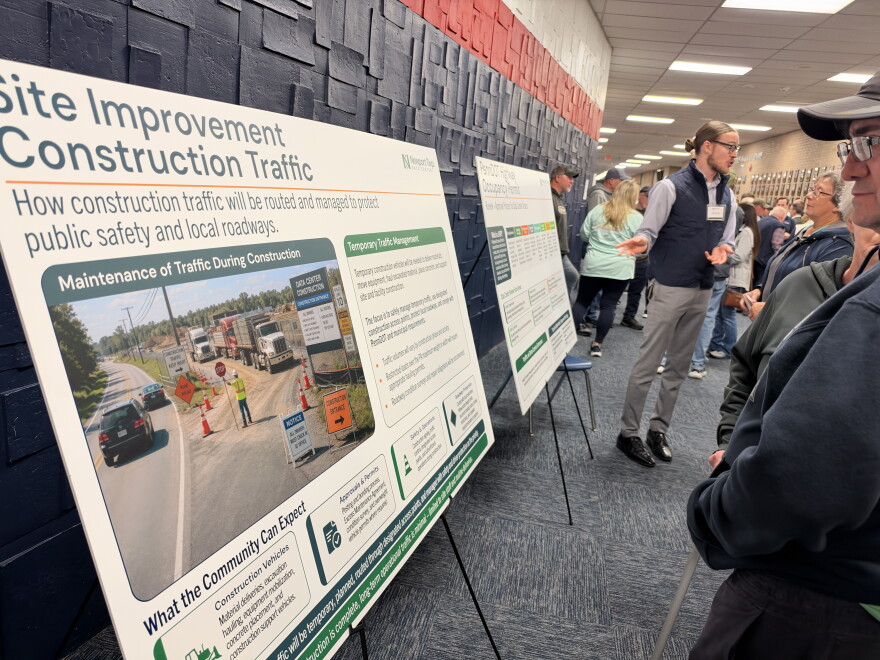 Residents look over display boards during the Newport Twp. Data Center Open House.
