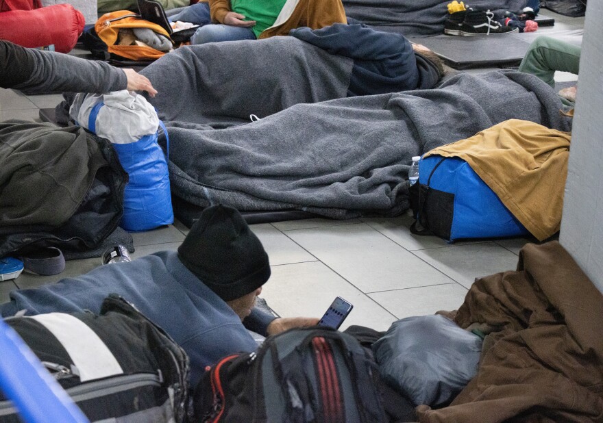 Guests at the United Caring Shelter settle in for the evening.