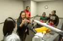 Geri Mitchell (second from left) talks with students from The Creative School recording spots for WAMU's "Lift Every Voice" project.