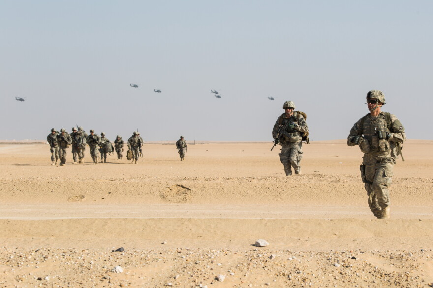 UH-60 Black Hawk helicopters from A Company, 3-142nd Assault Helicopter Company, 42nd Combat Aviation Brigade, circle after airdropping soldiers from A Company, 1-67th Armor Regiment, 2-4th Infantry Division, during a training exercise outside Camp Buehring, Kuwait, on Dec. 28, 2013. The New York Army National Guard's 42nd Combat Aviation Brigade was deployed overseas to operate rotary-wing aircraft in support of Operation Enduring Freedom.