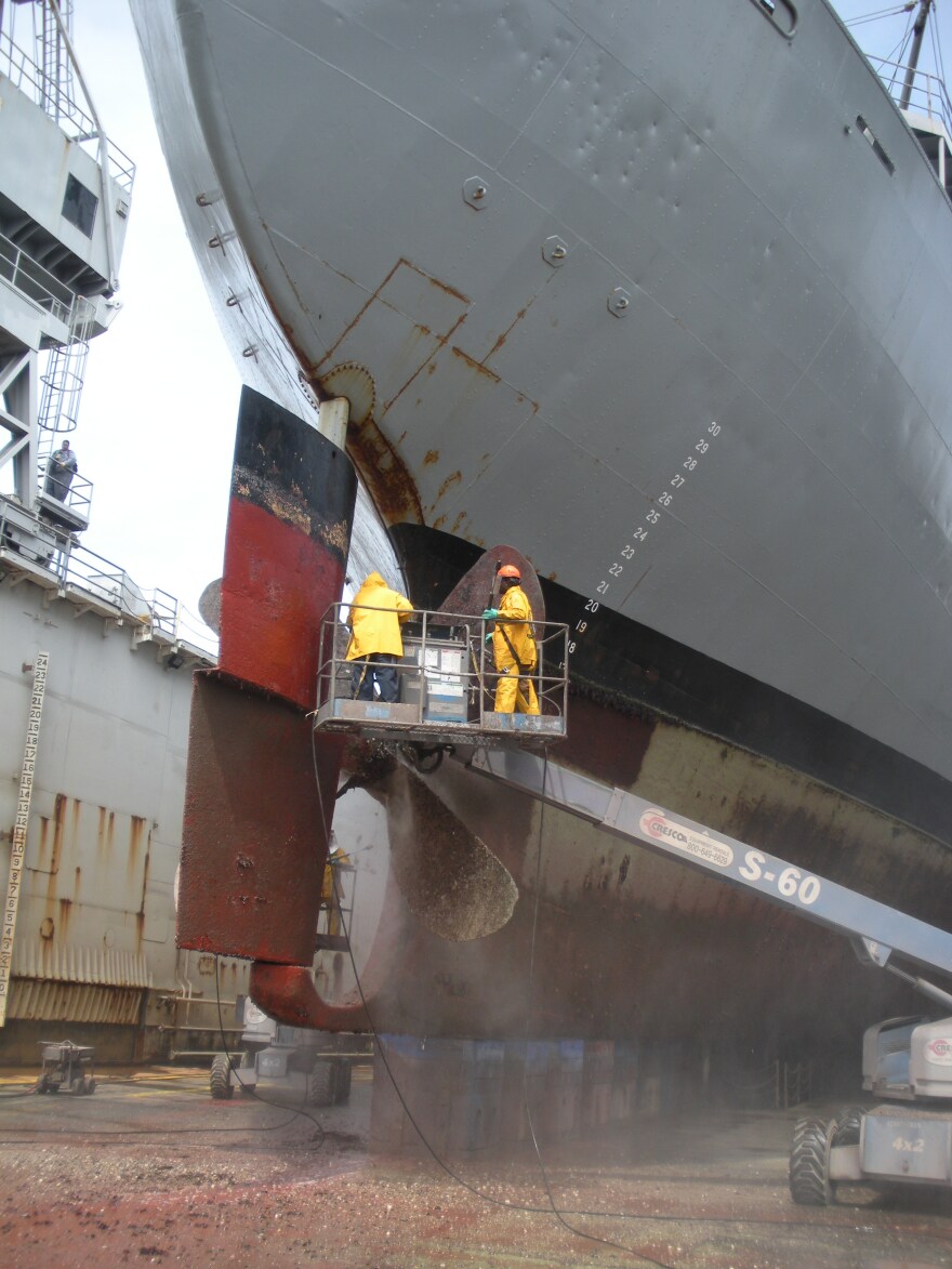 A ship's propeller is cleaned in a dry dock in California.