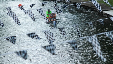 An all-male canoe racing team competes in the time trial sprint for the Au Sable Canoe Marathon on Thursday, July 25, 2024, on the Au Sable River, in Grayling, Mich.
