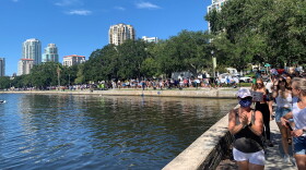 line of people walking along water