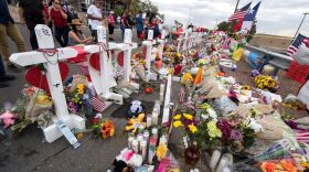 People leave flowers at a makeshift memorial for shooting victims at the Cielo Vista Mall Walmart, in El Paso, Texas.