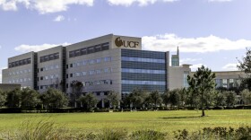 A white building with a gold UCF logo.