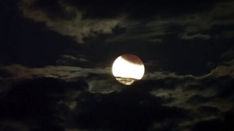 Photo of a partial lunar eclipse when Earth's shadow is seen on the Moon.