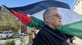 Liz Seaton singing a song for peace and Palestine outside the Cumberland County Courthouse in support of protesters being arraigned on July 24, 2025.