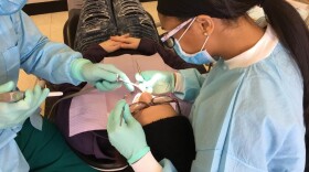Ratrice Jackson, then a fourth-year student at Meharry Medical College in Nashville, works with a patient as part of a free oral health day on campus in 2018.