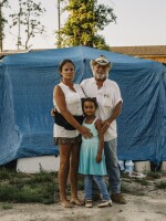 Shelly and Sam Summers stand with daughter Gabby in front of a makeshift shelter on their rural Bay County property. They opened their backyard to people who were homeless after Hurricane Michael. At the peak, about 50 people lived there. Now, there are 18. "We still have our home," Shelly says. "They have nothing. So if we can at least offer them the comforts of home, it was worth it."