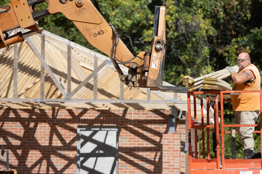 The new restroom between the pickleball and tennis courts are under construction currently. Here, contractors prepare materials for the roof trusses.