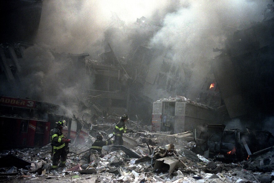 Firemen start to clean up the rubble of the North Bridge and the Wolrd Trade Center buildings.