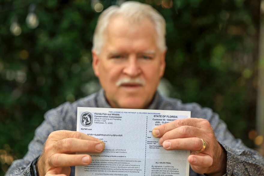 Joel Cleveland poses with his Florida bear hunting permit Friday, Dec. 5, 2025, in Tampa, Fla. (AP Photo/Mike Carlson)