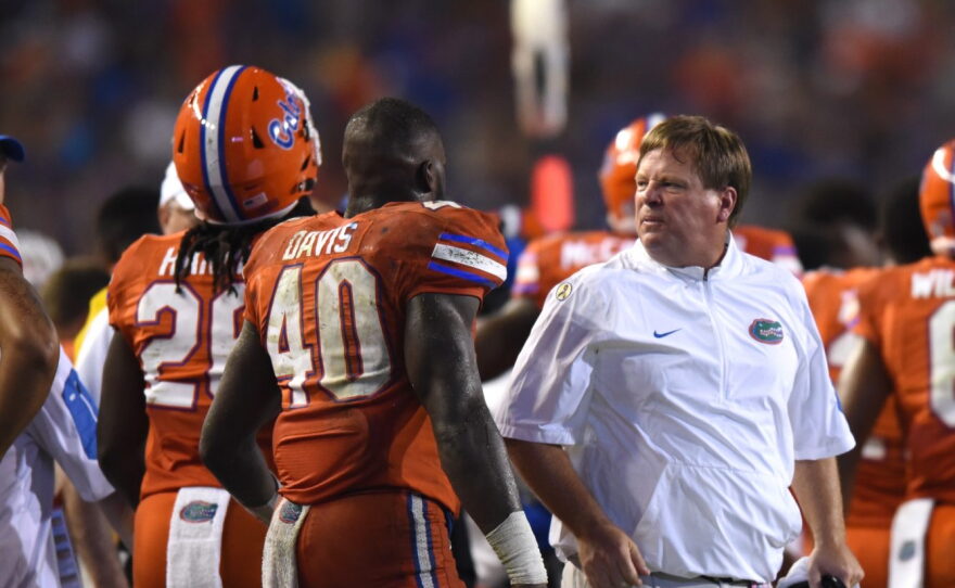 Florida coach Jim McElwain talks sternly to linebacker Jarrad Davis (40). McElwain was openly displeased about some of his player's behavior during the game. Florida committed 12 penalties, costing them 105-yards.