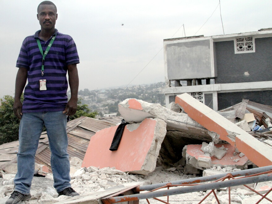 Suffrin Eddy, a mortician and political activist, has lived in the Fort National neighborhood all his life. Here, he climbed a toppled roof to show where two people were trapped alive. They were able to call out on their cell phones, he says, but there was no way to move the sheet of concrete, and after two days the phone calls stopped.