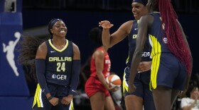 Dallas Wings' Arike Ogunbowale (24) Teaira McCowan, center, and Awak Kuier, right, celebrate after a basket by Ogunbowale in the first half of Game 2 of a first-round WNBA basketball playoff series against the Atlanta Dream, Tuesday, Sept. 19, 2023, in Arlington, Texas. (AP Photo/Tony Gutierrez)