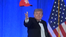 President Donald Trump tosses a "Trump 2028" hat at the White House Correspondents' Association dinner at the Waldorf Astoria Washington DC, Friday, July 24, 2026, in Washington. (AP Photo/Rod Lamkey, Jr.)