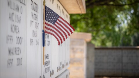 Miniature flag on grave at Fort Sam Houston National Cemetery on May 23, 2025.\