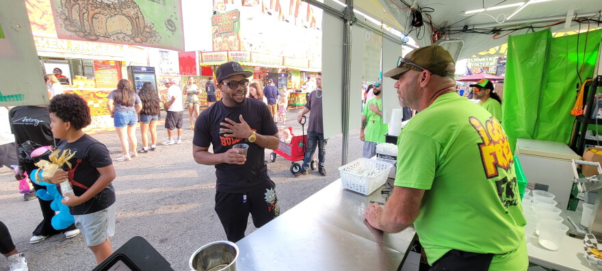 Jim Hasbrouck takes a customer's order at the Fried Specialties booth.