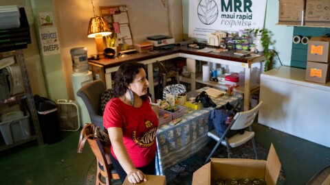 Nicole Huguenin, executive director of Maui Rapid Response, a nonprofit supporting Maui fire survivors with cash assistance, organizes canned food at the organization's warehouse in Kahului, Hawaiʻi, Wednesday, March 4, 2026. (AP Photo/Mengshin Lin)