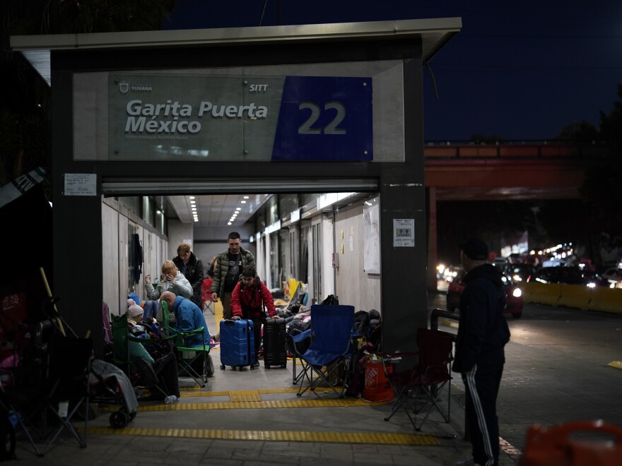 Ukrainian refugees wait in a bus stop near the Mexico border in early April. The arrival of hundreds of Ukrainians at the border since the war began has added more pressure on the Biden administration to lift Title 42.