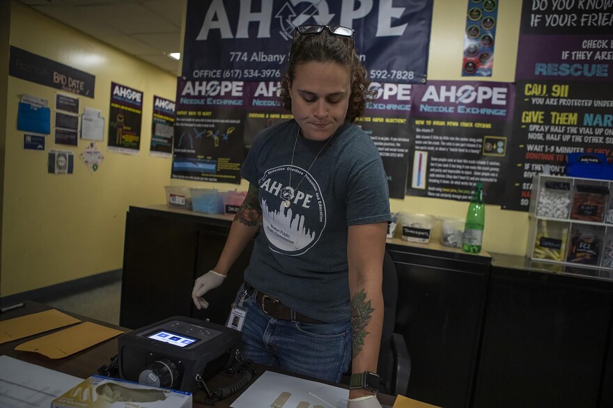The MX908 can check for the presence of fentanyl mixed with other drugs and such testing may help prevent overdoses. Sarah Mackin of the Boston Public Health Commission prepares the machine for testing some samples.