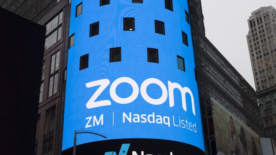 A sign for Zoom Video Communications is pictured ahead of the company's Nasdaq IPO in New York in 2019. The company has agreed to a preliminary settlement in a privacy lawsuit.