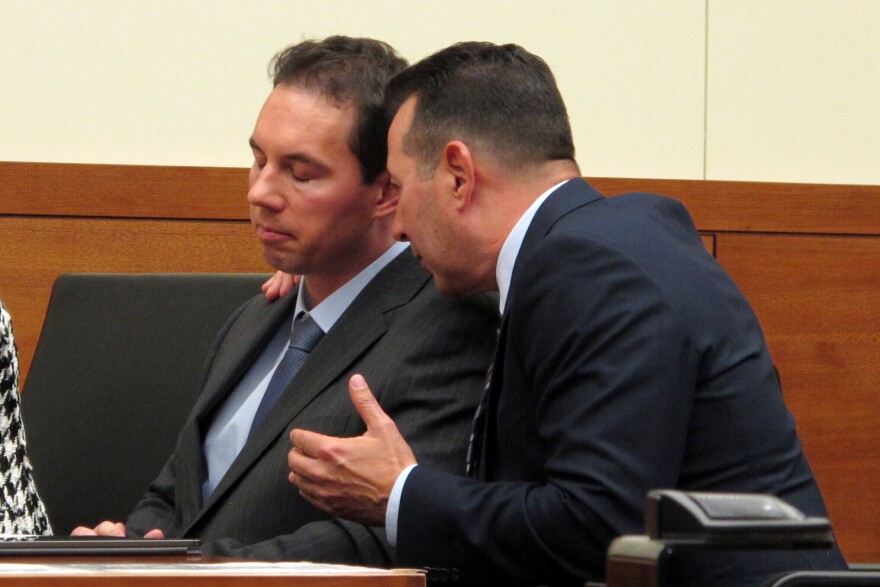 Defense attorney Jose Baez, right, talks to fired doctor William Husel during a court hearing Wednesday, Aug. 28, 2019, in Columbus, Ohio.