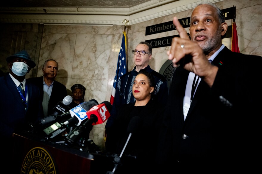 St. Louis Circuit Attorney Kim Gardner [center] listens as a staffer pushes back on a reporter question.