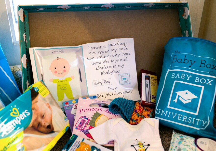 In Ohio, the free baby box comes with educational materials, books, diapers, wipes and clothes.