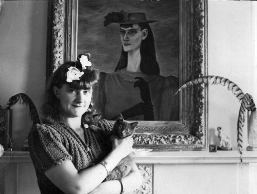 Gertrude Abercrombie holding her cat Mercy in front of her painting "Self Portrait of My Sister," after 1941. Illinois State Museum, Dinah Abercrombie Livingston Archives.