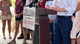 The Republican candidate for governor, Rep. Lee Zeldin, speaks Monday, Aug. 8, 2022, at the Stanton family's farm outside Albany against enacting a 40-hour overtime threshold for farmworkers. Rep. Elise Stefanik is to his left. 