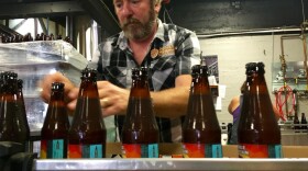 Double Mountain Brewery founder Matt Swihart grabs freshly bottled pale ale from the bottling line in Hood River. The brewery's new beer is among the first to be sold in Oregon's new refillable beer bottles. CREDIT: CASSANDRA PROFITA