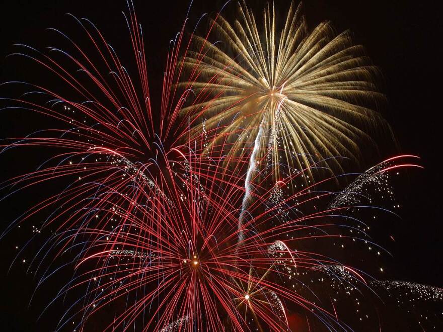 red and yellow fireworks on a black sky background