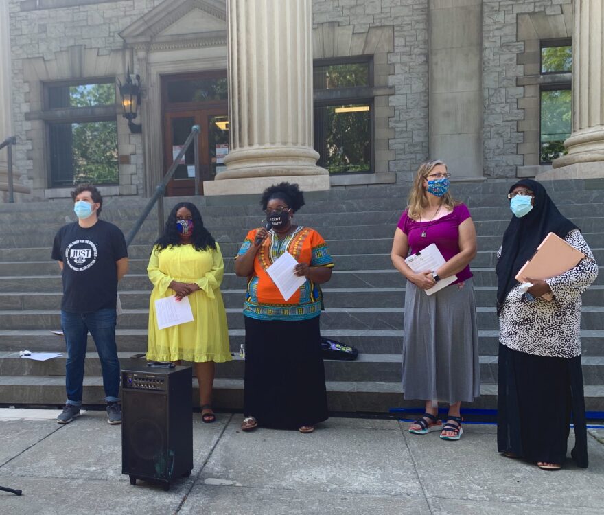 Representatives of the People's Protection Plan Coalition speak outside the Broome County Courthouse. (Jillian Forstadt/WSKG)