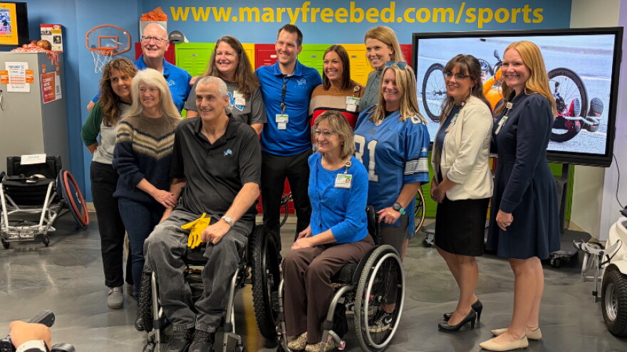 Former Detroit Lion offensive lineman Mike Utley (center, black shirt) meets with Mary Free Bed employees and tours the hospital's Wheelchair and Adaptive Sports program.